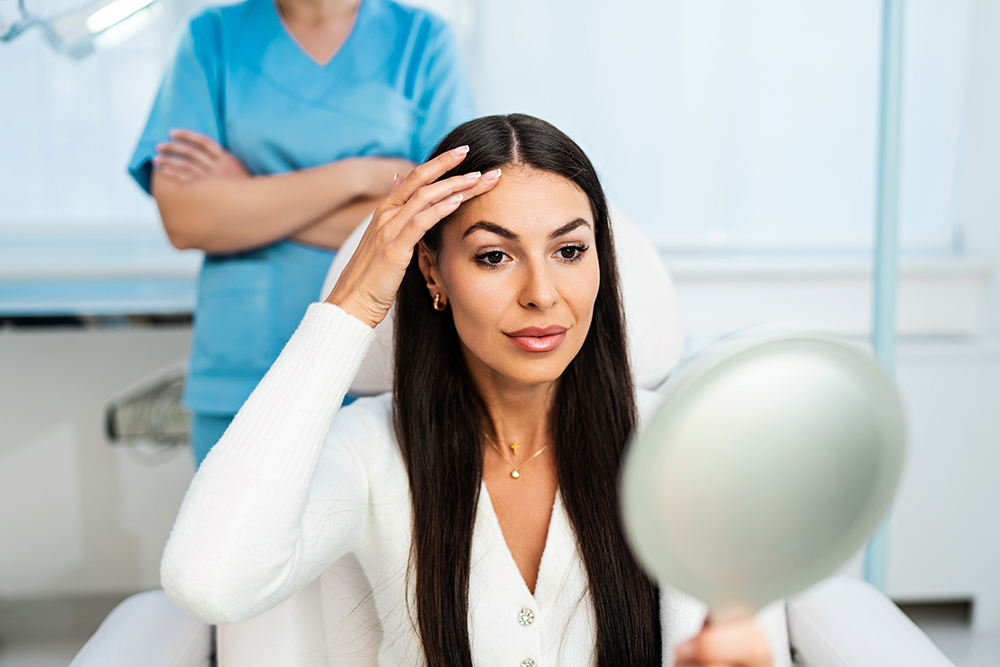 Beautiful and happy young woman sitting in medical chair and loo Needle Nurse Aesthetics toxin top up policy